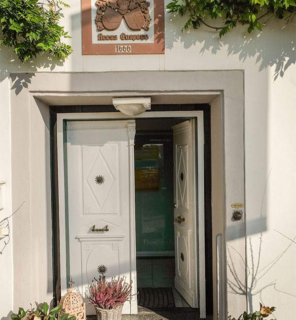 The white front door of the villa, beneath a plaque dated 1666.