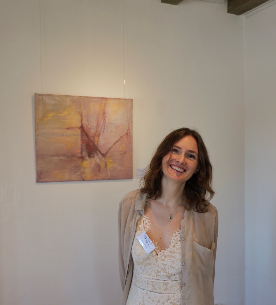 A visitor beside a painting in the gallery.